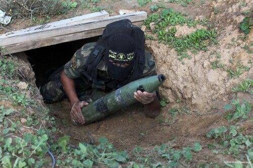 Palestinian militant from al-Quds Brigades carries a rocket during military exercises in the Hamas-run Gaza on 16th December 2012.