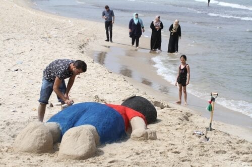 Artista palestino se gana la vida esculpiendo arena recrea la imagen icónica de cuando el cuerpo del refugiado sirio Alan Kurdi llegó a las costas turcas
